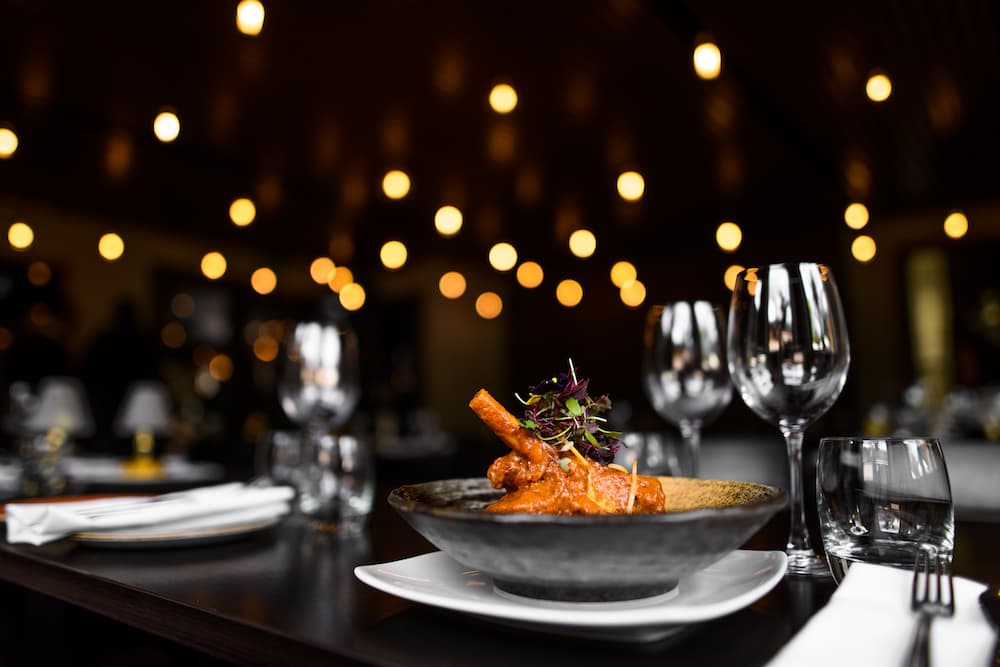 A beautiful dish on a table in Little India's mood lit restaurant as they give ideas for your next date night